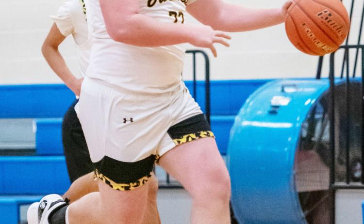 Senior Yellowjacket Tate Wagner makes his way down the court in the Jackets’ district win over Olfen. Nora Davis, photo.