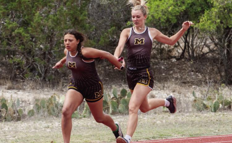Mackenzie Compton hands off to Perla Pecina in the girls 4x100m relay (second place).
