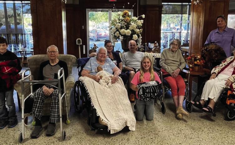 Menard 4-H members made lap knot blankets for residents. Pictured (l to r): Perry Lange, Caeson Lowrance, Wilford Wagner, Edith Nasr, Occupational Therapist Tara, John Bennett, Linah Wright, Laverne Benton, Lisa Brown, Nellie Frnka, and Saydee Meadow. Courtesy Photo.
