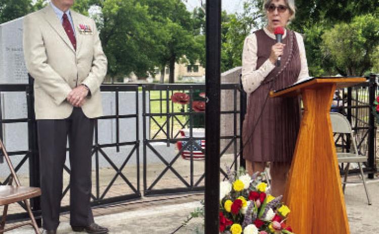IN MEMORIAM- Terry Kelley, left, joins Christi Gonzales Fairley during a Memorial Day tribute at Menard’s American Legion Park war memorial on Monday, May 26. Fairley is the niece of Private First Class Emiliano G. Gonzalez, United States Army, who was featured at Monday’s program. Courtesy photo.