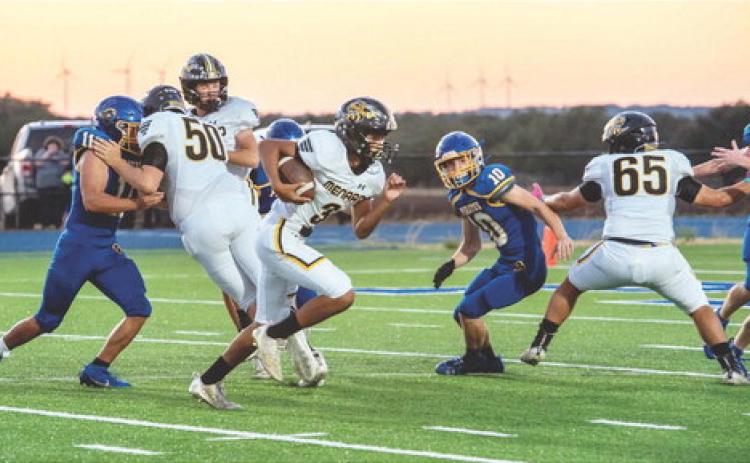 SEE YA- Sophomore Yellowjacket Jayden Payton, center, takes advantage of good blocks from Logan Powell (back), Aidan Ramon (#50), and Jadon Torres (#65) in Priddy last week. The Jackets 45'd the Pirates at the half last week, 49-0. Nora Davis, photo.