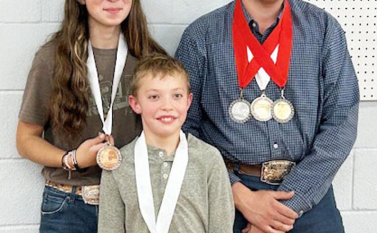 Mia Estrada, Walker Hines and Larkin Loeffler show off their medals at the 2024 Heart of Texas indoor match. Courtesy photo.