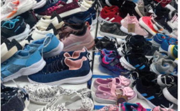 The First Blessing ministry brought hundreds of shoes from sizes infant to 12 and beyond for the shoe blessing at Monday’s back-toschool event. TMN photos.