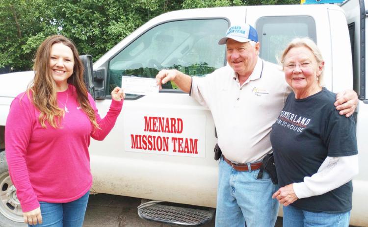 Katie Simmons Parker (left), Houston's sister, presents a memorial donation to Steve Whitson with the Menard Mission Team. Katie and Whitson are joined by mama Simmons, Marga (far right). Courtesy photo.