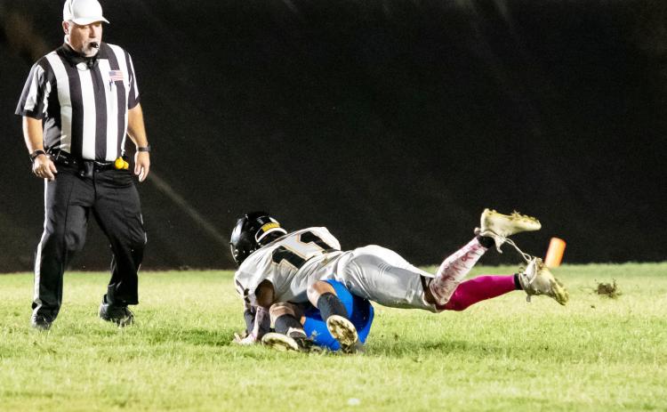 SACK-ZILLA- Yellowjacket Maddox Saiz, #11, gets a good clean shot on the Medina quarterback during Menard’s district win last week.