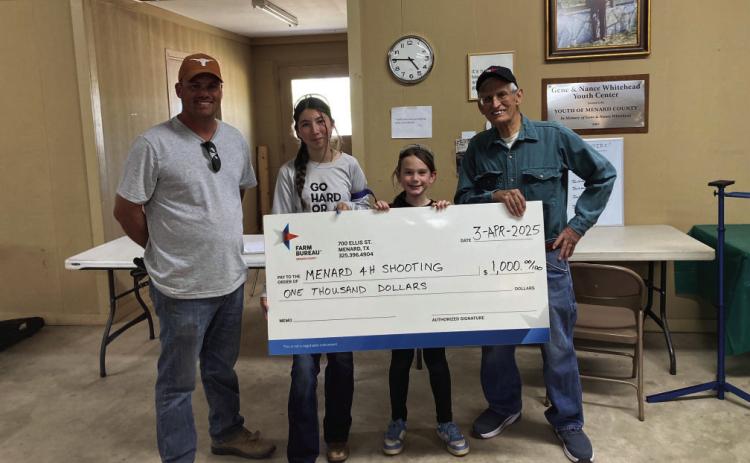 Menard County Farm Bureau board member Tyson Roll presents a check for $1,000 to the Menard 4-H Shooting Sports program. Shooters Mia Estrada and Kylie Smith graciously accept the donation check with Coach David Hand. Courtesy Photo.