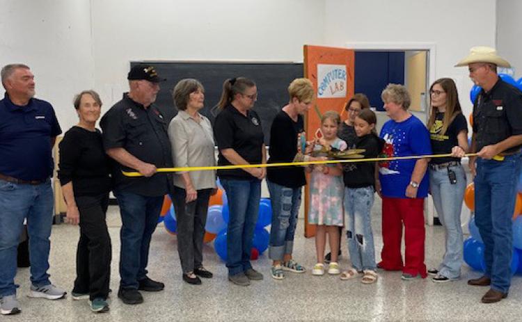 Optimum representatives, Boys &amp; Girls Club Board members, and Club staff are joined by Menard Chamber of Commerce directors to cut the ceremonial ribbon which signified the official opening of the new, state-of-the-art computer lab at the Club. All aspects of the lab were provided by Optimum- from renovations to equipment. Courtesy photo.