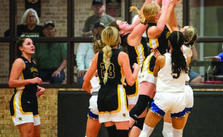 A SWARM OF LADY ‘JACKETS- work to block the shot in an intense game against state ranked Veribest. Lady ‘Jacket photos by Sandy Kothmann.