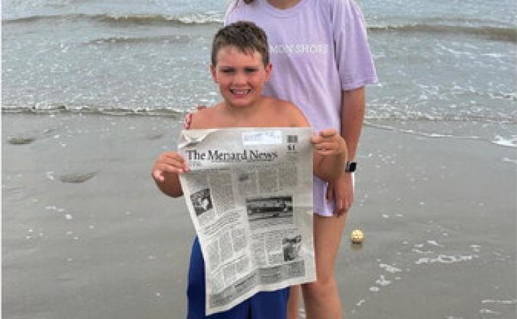 Abraham Hill and Ayden Matlock enjoyed The Menard News at Cinnamon Shore in Port Aransas, Texas. Where will it go next? Courtesy Photo.
