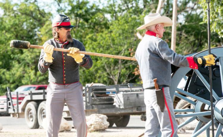 RIGHT- Historical reenactors Wayne Carlile and Buck Bostwick prep the 'Alamo' canon to fire last Saturday. Sandy Kothmann, photo.