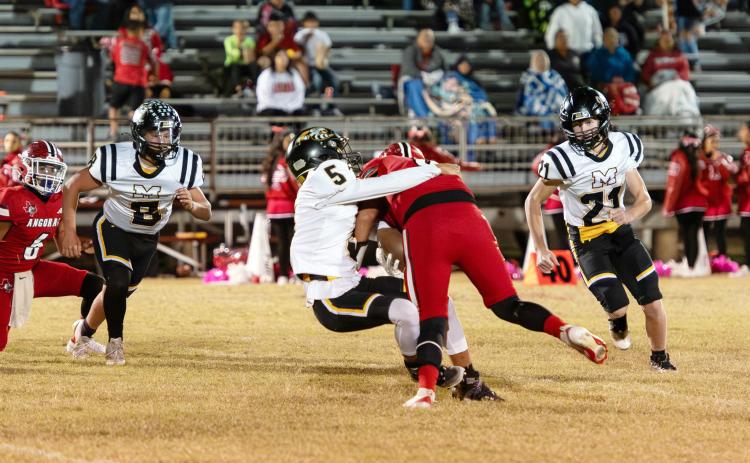 SOPHOMORE SWARM- Mack Davis (#8), Marlee Salas (#5), and Kade Bannowsky (#21), all sophomores, zero in on an Angora ballcarrier in Rocksprings last week. The 48-44 non-district win provided valuable opportunities for the team's talented underclassmen to gain some quality playing time. A win for the undefeated Jackets in Eden this Friday will claim the outright district championship to finalize the regular season. See additional football photos on page 8. Photo by Nora Davis.