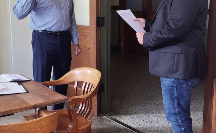 Newly elected (George) Randy Corbin repeats the oath of office as the new County Chair of the Menard County Republican Party. County Judge Brandon Corbin, Randy's son, administered the oath on Monday. TMN photo.
