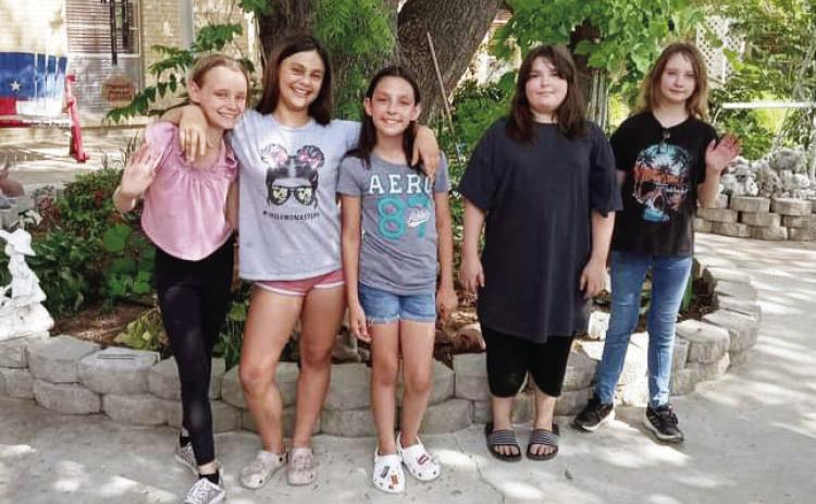 JUNIOR GIRLS SCOUT TROOP #5253, left to right: Aerie Meddaugh, Sara Ogden, Kelsie Aguirre, Avery Schuler, and Molly Brown. The troop planned and executed their project by purchasing and planting flowers at Menard Manor last week. Not pictured: Kayla Trimble and Nayeli Hernandez. Courtesy photo.