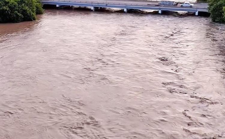 the San Saba River near its peak rise on Friday evening, July 17, 2026, looking east to west, from just above the low water crossing in town. Photo by Rafter N Media.