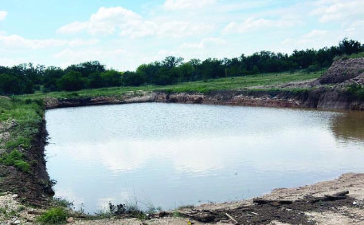DO NOT BE FOOLED! This is not a refreshing rural watering hole, but instead the city dump pit full of rainwater. With a liquid capacity of 788k gallons, the pit took more than two weeks to pump dry in preparation for this weekend's rescheduled Citywide Cleanup. Photo courtesy City of Menard.