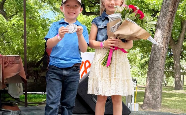 JIM BOWIE DAY ROYALTY- A popular holdover from the original Jim Bowie Days is the Little Mr. &amp; Miss Silver Nugget contest. Youngsters are interviewed on stage and judges determine the winners. This year’s titles go to Waylon Fairless (5) and Anna Jo Hicks (6), both grandchildren of Paige and Johnny Hicks of Menard. Additional coverage of the weekend festivities will be included in next week’s newspaper. Chamber photo.