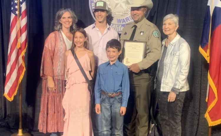 MEDAL OF VALOR recipient, Game Warden John Compton, accepted his prestigious award in a ceremony in Austin on October 23, 2025. There to celebrate the recognition are, pictured front row left to right: two of John's children, Natalie and Deacon Compton. Back row: John's sister Amanda Gross, son Wesley, John, and his mother Linda Compton. Courtesy photo.