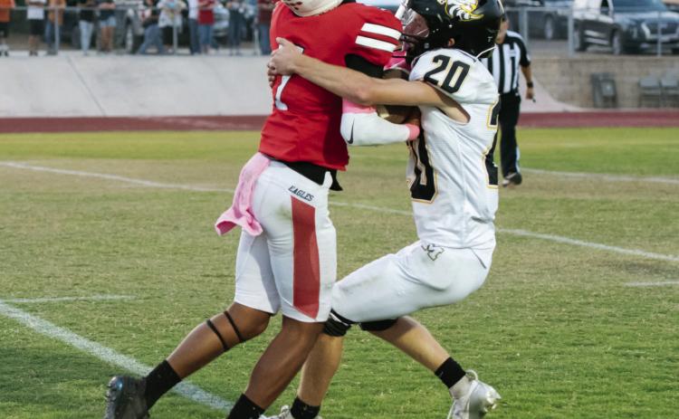Bryce Davis (#20) wraps up his mark during the Jackets’ district win over Leakey on Friday. Davis’s performance earned him Yellowjacket Defensive Player of the Week.