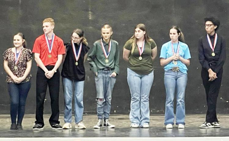 MENARD ONE ACT PLAY cast members Kailey Zimmerman (far left) and Kylee Sommerville (third from right) stand on stage -with fellow honorees from competing schools- to accept their All-Star Cast awards in Santa Anna on Monday. Other Yellowjacket recognition went to Tristan Wilson, All-Star Crew, and Khloe McCaffery, Honorable Mention Cast. Courtesy photo.