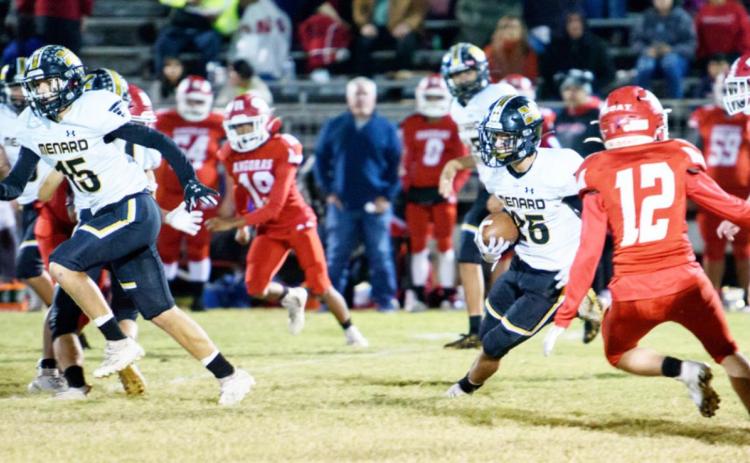 CAN’T CATCH ME! Senior Yellowjacket Orlando Resendiz, #25, picks his way through the Rocksprings defenders as he runs back a kickoff to score a touchdown, one of two TDs for #25 that evening. Teammate Joel Guerrero, #15, helps block for him. Resendiz ran back two Angora kickoffs to score in both the first and third quarters. Nora Davis, photo.