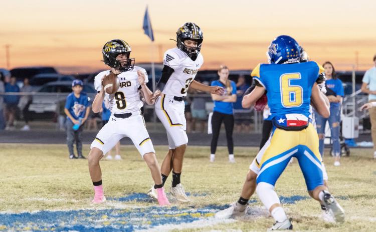 Under the watchful protection of sophomore Jayden Payton, junior Logan Powell (8) steps back to find a receiver during last week’s district game in Veribest. The Yellowjackets lost the game, 58-8. “We have to find better ways to come out and compete and give ourselves a better chance early in games,” said head coach Bryson Oliver.