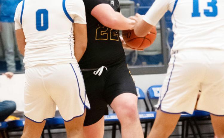 A WELL EARNED CHARGE- Photographer Nora Davis captured this succession of senior Yellowjacket Tate Wagner, center, bulldogging an Eden Bulldog on his way to the basket during the Jackets' loss to Eden last week. In order to claim a share of the district title, the Menard boys must win their last 2 regular season games against Rochelle and Panther Creek. Nora Davis, photos.