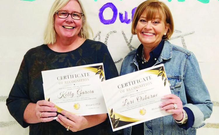 Veteran teachers Kelly Garcia (l) and Lori Osborne (r) accept PTO Lifetime Membership Awards for their dedicated years of service to Menard students and PTO. Courtesy Photo.