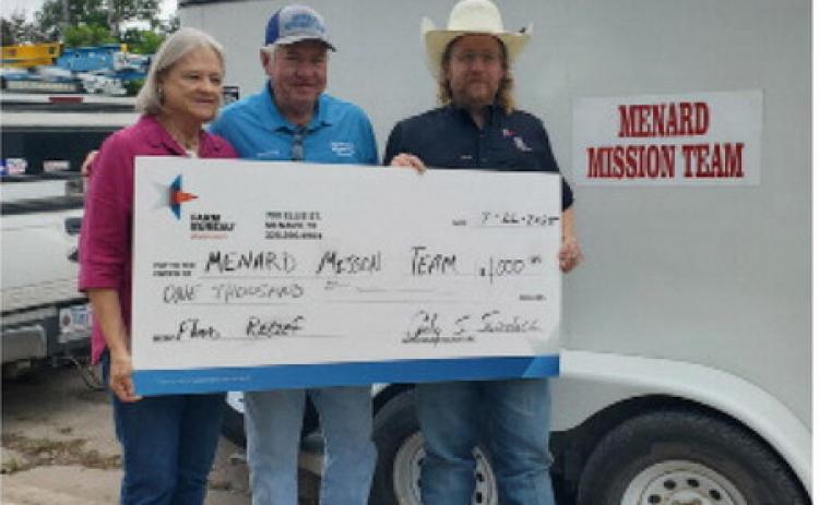 ABOVE- Farm Bureau Board of Directors President Cody Swindall (right) presents the Menard Mission Team representatives Steve Whitson (center) and Charlotte Albrecht a donation check for $1,000 to help with flood disaster property recovery and restoration. Kristin Wilson, Menard County Farm Bureau photo.