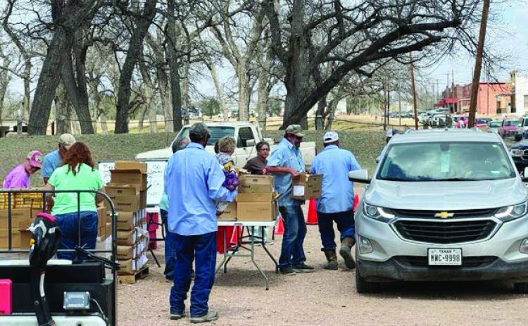 ABOVE- City employees and several community volunteers worked hard to pack and distribute grocery staples to more than 150 families. San Antonio Food Bank provided the food. TMN photo.
