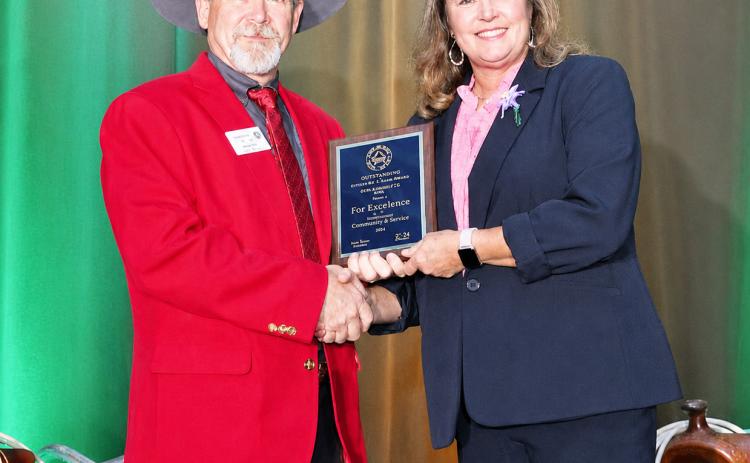 LEFT- National Association of County Agriculture Agents (NACAA) President J.J. Jones presents Menard County AgriLife Extension Agent Lisa Brown with one of the industry’s highest honors, the Distinguished Service Award. Courtesy photo.
