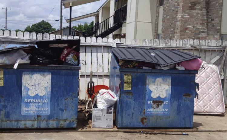 Trash was found stacked between and behind overflowing dumpsters at the Deer Creek and Silver Trail Apartment complexes. Both complexes to press charges if perpetrators are identified. Michael Owen photo.