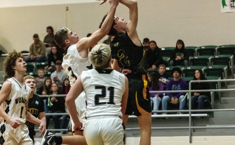 ELI WEATHERLY resists the hand holding offer of a Water Valley Wildcat during Menard's bidistrict loss this week. Nora Davis, photo.