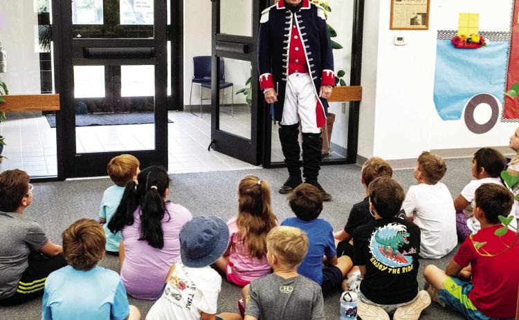 In a file photo, Colonel Terry Kelley (RET) volunteers during a summer reading activity last summer. The summer reading program is always free of charge and will start in June.