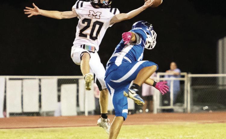Yellowjacket Bryce Davis, a junior, leaps up for an interception against the Nueces Canyon Panthers in Menard's 82-54 win last week. The Jackets are 3-0 in district play. They are open this week, then face Eden at home to complete district next Friday, November 8. Nora Davis, photo.