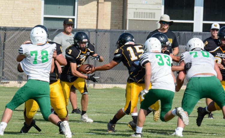 HANDOFF- Senior Jordan McSherry hands off the ball to junior Joel Guerrero during the Yellowjackets’ scrimmage against Cross Plains last Thursday. Although the score was not officially kept, the Yellowjackets are happy with how they played and consider it a personal win. Photo by Sandy Kothmann.