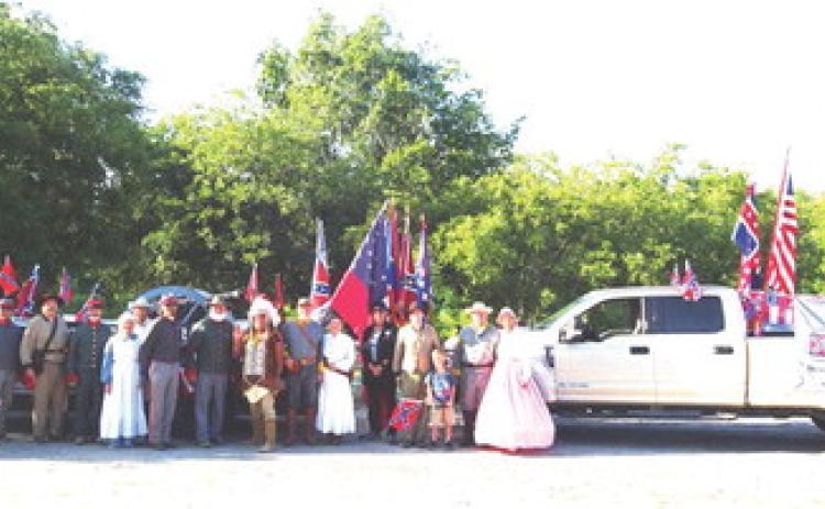 MARCHING THROUGH TIME- Several area Sons of Confederate Veterans camps got together to participate in Bandera’s Labor Day parade. The whole group is pictured above with their prize-winning parade entry. Menard participants include: Buck Bostwick; Eddie Bostwick; Mike McCammon; Gary Bates; Katherine and John Kniffen; Wayne Carlile; Barry Kniffen; Chief Broken Eagle, Ray Hernandez; three SCV members from Medina; Don and Bonnie Taylor. Courtesy photo.