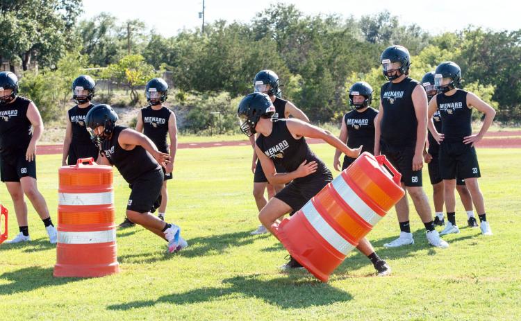 ON THE MOVE- Juniors Zeke Hernandez and Cado Bannowsky work through some barrel drills during a summertime Jacket football practice. The team will brave hot temperatures Thursday afternoon to host Panther Creek and Gorman beginning at 6. Nora Davis, photo.