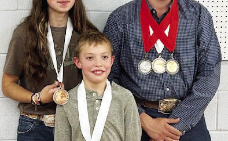 Menard Rifles medal at Heart of Texas match: (l-r) Mia Estrada, Walker Hines and Larkin Loeffler. Courtesy photo.