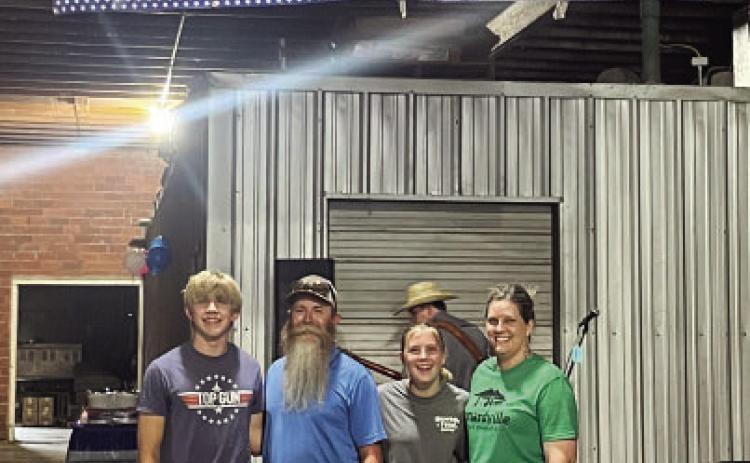 INTRODUCING MENARDVILLE FEED CO., Formerly Compton Warehouse. The Burch family celebrated 20 years of business Saturday, complete with live music, food, door prizes and of course, the unveiling of the store's new name. Pictured is the family behind the last 2 decades, Benjamin, Brandon, Caitlyn and Cristy Burch. See more on page TMN photo.