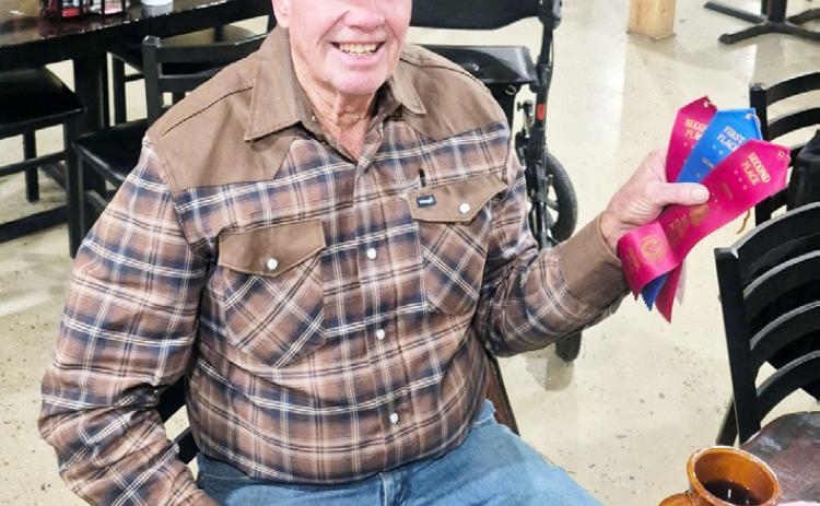 ABOVE- Bill Doyle displays his awards from December’s Menard County Pecan Show. BELOW- John, Barry and Billy Kniffen, along with Bill Doyle, tend to business during the 2025 county pecan show. Courtesy photos.