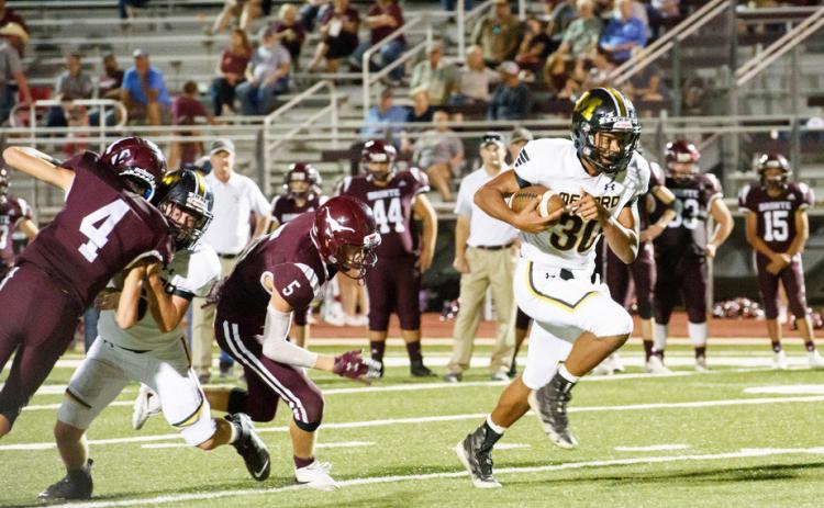 FASTER THAN A SPEEDING LONGHORN- Senior Yellowjacket Isaiah Stanislawski outruns a Bronte Longhorn on his way to one of his 3 touchdowns in Menard’s win over Bronte last Friday. The game was called at the half, as Menard was up 50-0. N. Davis, photo.