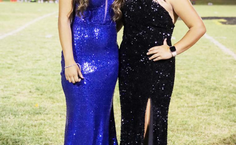 LEFT- Nadia Garcia, Band Sweetheart, and Football Queen Tatum Ruiz pose together following the crowning at halftime of Friday's Homecoming game. Read about the girls and their court on page 8. Laressa Brown, photo.
