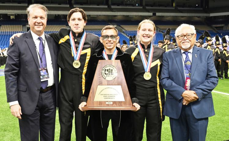 U.I.L. CLASS A STATE MARCHING BAND CHAMPIONS! AGAIN! Pictured with contest officials at the Alamodome Tuesday night, Drum Majors Aydan Wilson (second from left), Kevin Johnson and Cozette Halley accept their gold medals on behalf of the Yellowjacket Band. Details and additional photos will be included in next week's newspaper. Photo by Jolesch Enterprises.