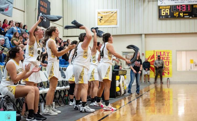 The Lady Jacket bench cheers their teammates on the court during a decisive at home win over Iraan Saturday. Sandy Kothmann, photo.