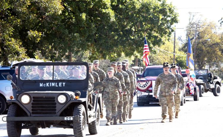 LEFT RIGHT LEFT- The Goodfellow AFB Charlie Co. 344 MI Battalion traveled from San Angelo to help lead Saturday’s annual PTO Veterans Day Parade in Menard. Capel. Sager from Eden (driver), and RET/COL Terry Kelley (left, passenger) fall into the parade procession behind the Girl Scouts as leaders. Nora Davis, photo.
