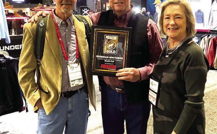 Gary and Deb Roberson, middle and right, owner/operator of Burnham Brothers won SHOT Show 2024 Mouth Blown Call of the Year presented by Gordy J. Krahn of Predator Xtreme magazine. Courtesy Photo.