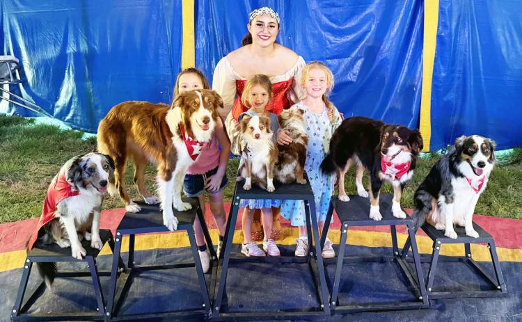 YOUNG CIRCUS-GOERS Byler Barrett (she’s back there!), Reece Johns and Selah Roberson were able to meet Miss Gianna and her performing dogs after a performance of the Culpepper &amp; Merriweather circus on Sunday in Menard. Courtesy photo.