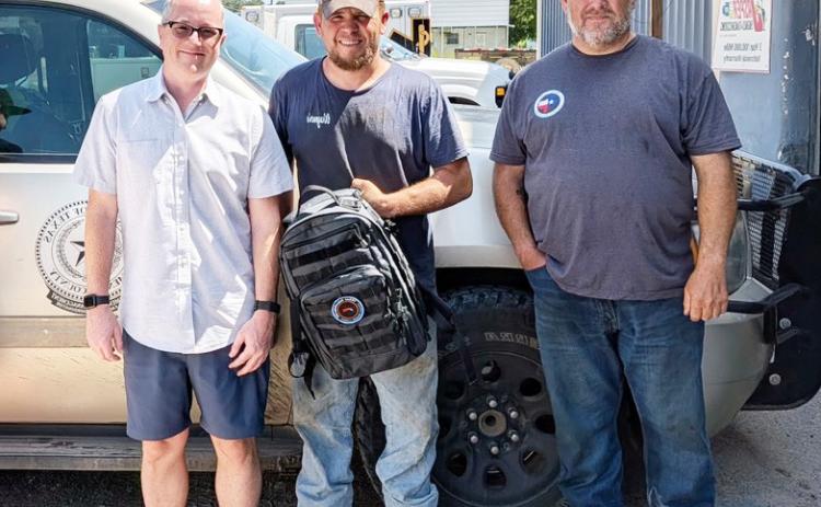 Richard Moreland, left, with Texas DisasterLink presents MVFD Chief Tyler Wagner and Menard County Emergency Management Coordinator Jeff Whitson with communication equipment and services to maintain connectivity for first responders during emergencies. Courtesy photo.