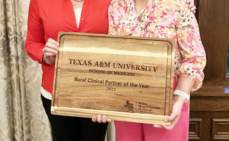 Frontera Executive Director Mikki Hand, right, accepts the clinic's rural medicine award. Courtesy photo.