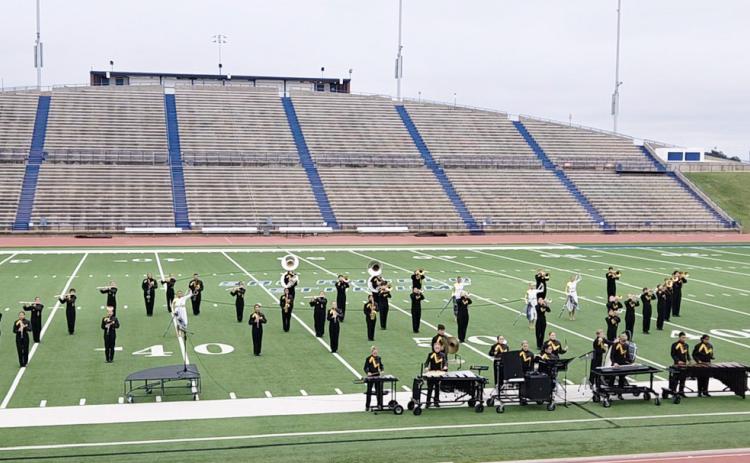 ABOVE- Menard’s award winning marching band swept the Concho Classic Marching Festival in San Angelo on Saturday winning Best Overall 1A Band, Best Brass, Best Woodwinds, Best Percussion and Best Color Guard. Myghan Meadow, photo. LEFT- Drum Major Kailey Morris displays the band’s pile of accomplishments from the Concho Classic at San Angelo Stadium this weekend. Courtesy photo.